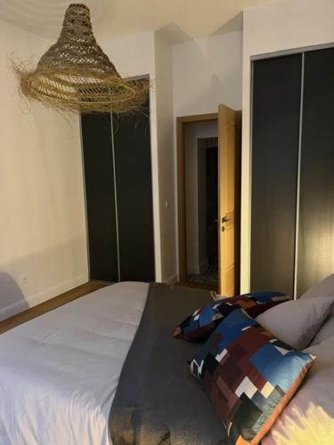 a bedroom with a bed with a pillow on it at centre ville Chalon sur Saône in Chalon-sur-Saône