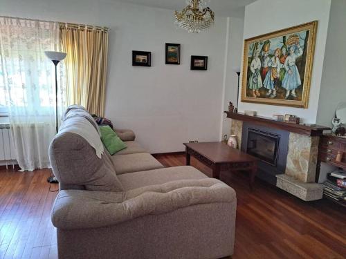 a living room with two couches and a fireplace at Casa Ares in Cee