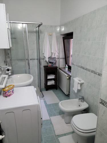 a bathroom with a sink and a toilet and a shower at La Vecchia Riseria 1 in Novara