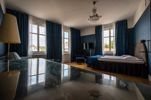 a bedroom with a bed and a glass table at Hotell Hertig Karl in Filipstad