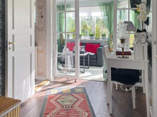 a living room with a white door and a table and chairs at Holiday home JÖNKÖPING III in Jönköping