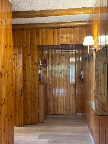 a large room with wooden walls and wooden panels at Ridge Line in Ponte di Legno