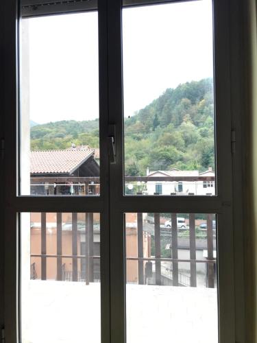 an open window with a view of a building at AL CAMPANILE centro storico ampio luminoso e panoramico appartamento trilocale in Carsoli