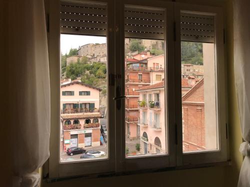 a window with a view of a city at AL CAMPANILE centro storico ampio luminoso e panoramico appartamento trilocale in Carsoli