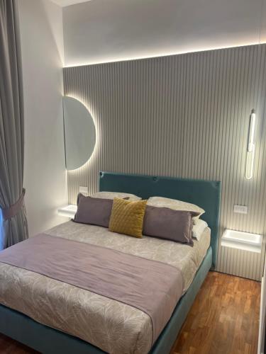 a bedroom with a bed with purple and yellow pillows at La Lepre felice-bovio in Naples