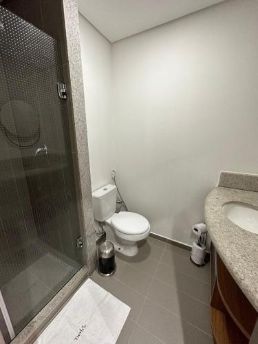 a bathroom with a shower and a toilet and a sink at TrevizZo São Caetano do Sul in São Caetano do Sul