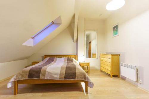 a bedroom with a bed and a skylight at Zakole Wiaru in Wojtkowa