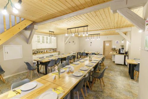 a large dining room with wooden tables and chairs at Zakole Wiaru in Wojtkowa