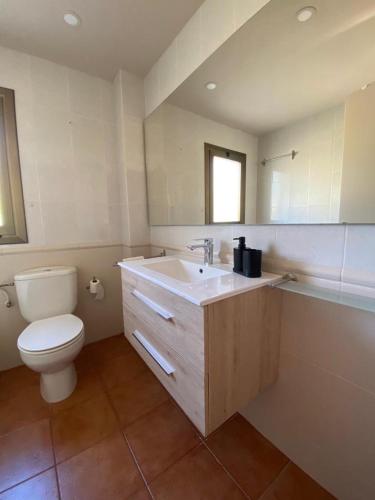 a bathroom with a toilet and a sink at Kalma House in Torroella de Montgrí