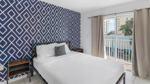 1 dormitorio con 1 cama y una pared azul y blanca en Gorgeous 2 2 Hospitals Ballpark Downtown Parking, en Miami