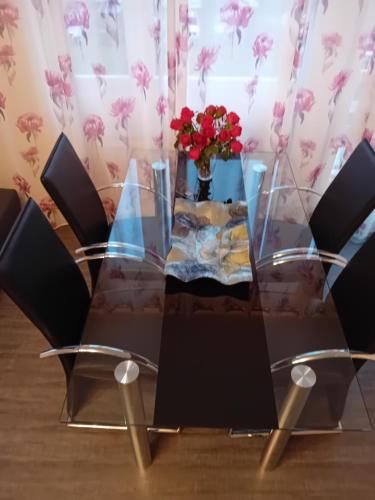 a glass table with a vase of flowers on it at Monte Cristo in Metz