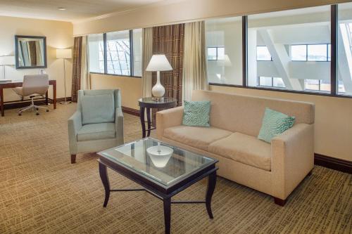 a living room with a couch and a table at Crowne Plaza Hotel St. Louis Airport by IHG in Bridgeton