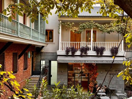 people sitting at tables in front of a house at Terrace Tbilisi Center in Tbilisi City