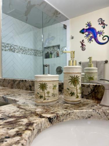 a bathroom counter with three towels and a sink at Always Summer On a White Sandy Beach in Fort Myers Beach