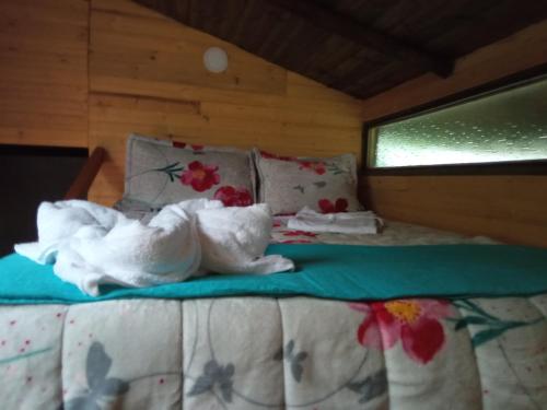 a bed with two white animals laying on it at La cabaña de sol in Aquitania