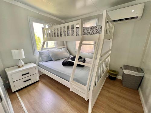 a white bunk bed in a room with a window at Tony's Travels in Camaceyes