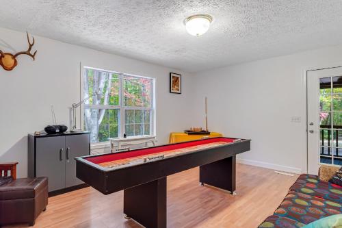 a room with a pool table in the middle of it at Relax at Saddleback in Mill Spring