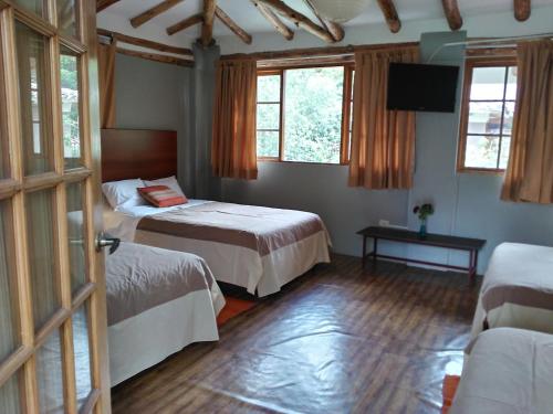Ένα ή περισσότερα κρεβάτια σε δωμάτιο στο Hotel Pisonay Pueblo