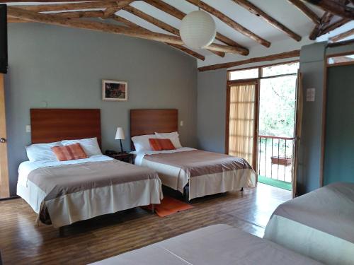 Postel nebo postele na pokoji v ubytování Hotel Pisonay Pueblo