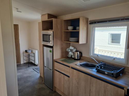 a small kitchen with a sink and a window at 58 Lancaster crescent in Tattershall