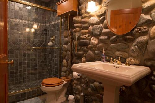 a bathroom with a sink and a stone wall at Big Luxury South Lake Tahoe Home in South Lake Tahoe