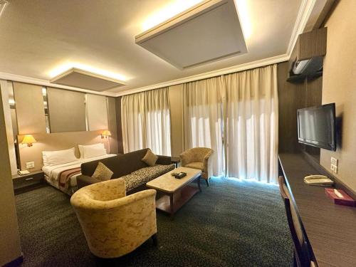 a hotel room with a couch and a bed at Padova Hotel in Beirut