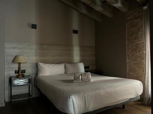 a bedroom with a bed with two pillows on it at Apartment Plaza de la Merced in Valencia
