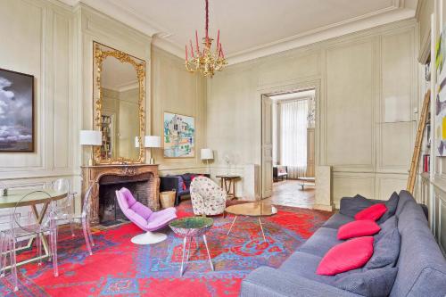 a living room with a couch and a dining room at Splendid appartment in the heart of Paris - Welkeys in Paris