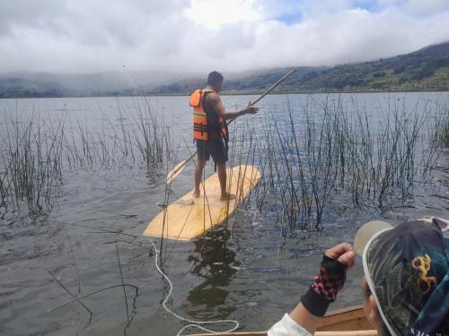 a man on a paddle board in the water at La cabaña de sol in Aquitania