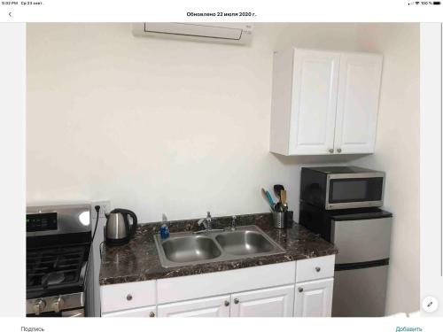 a kitchen with a sink and a microwave at Brooklyn Beach Location in Brooklyn
