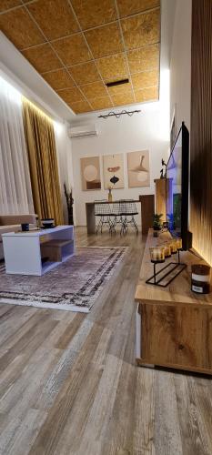 a living room with a flat screen tv and a couch at LUXURY APARTMENT in Tirana