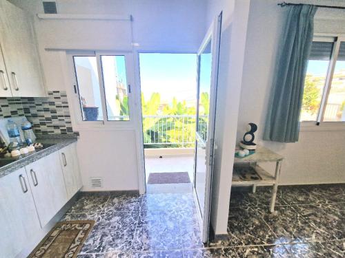 a kitchen with a door leading to a balcony at Cozy House Casa de los Abuelos in Icod de los Vinos by in Icod de los Vinos