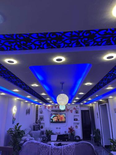 a living room with blue lights on the ceiling at Pyramids sunrise in Cairo