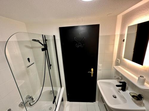 a bathroom with a black door with a spider on it at Ferienwohnung zwischen Hafen und Stadt in Bregenz