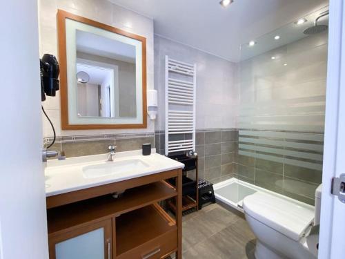 ein Badezimmer mit einem Waschbecken, einem WC und einem Spiegel in der Unterkunft Espectacular Apartamento Con Vistas En Escaldes - 10min Caminando Al Centro - Parking Gratis in Escaldes-Engordany