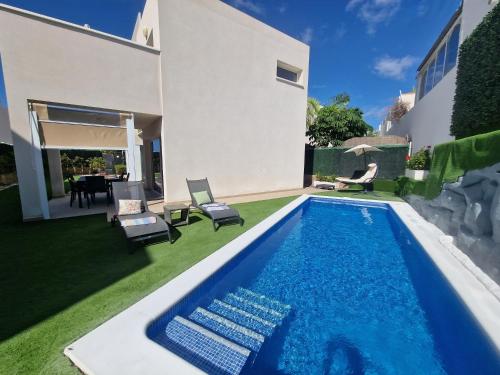 a swimming pool in the backyard of a house at Villa Paraiso-Luxury Villa with Heated Pool in Adeje