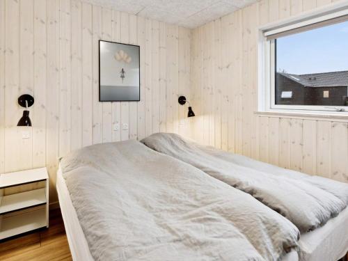 a white bedroom with a bed and a window at Luxury Villa with Pool - By Traum Ferienwohnungen in Kongsmark