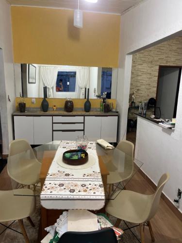 a kitchen with a table and chairs in a room at Casa in Itu