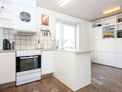 Thyborønにある8 person holiday home in Thybor nのキッチン(白いキャビネット、コンロ付)
