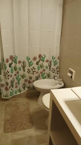 a small bathroom with a toilet and a sink at Mi casa, tu casa. Entre Plottier y Neuquen. in Neuquén