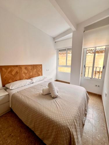 a white bedroom with a bed with a pillow on it at APARTAMENTO SANMIGUEL CENTRO in Córdoba