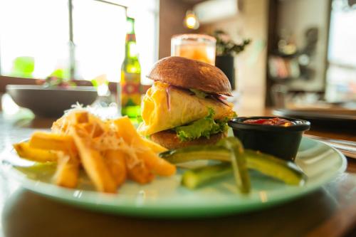 a plate with a sandwich and french fries on a table at Hotel Nacional Merida in Mérida