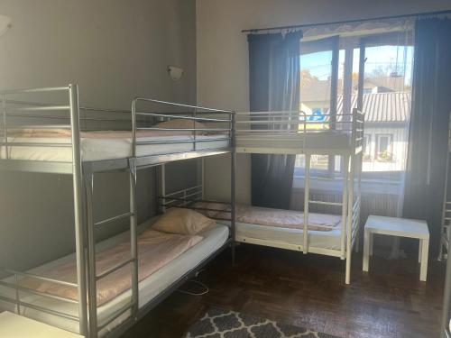 two bunk beds in a room with a window at 4 Couples & 4 Friends Hostel in Krakow