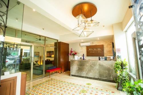 a lobby of a building with a counter and a room at Hotel Nacional Merida in Mérida