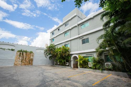 a large white building with a parking lot at Hotel Nacional Merida in Mérida