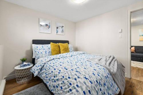 a bedroom with a bed with a blue and white comforter at Quite 1 bedroom apartment. in Dieppe