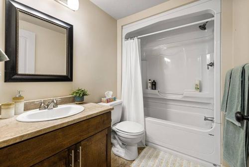 a bathroom with a sink and a toilet and a mirror at Quite 1 bedroom apartment. in Dieppe