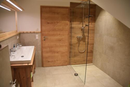 a bathroom with a shower and a sink at Ferienwohnung beim Hainz in Dietramszell