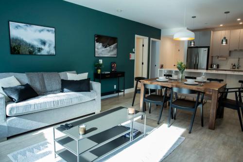 a living room with a couch and a table at Ski & Tee Retreat Bright Three Bedroom and Hot Tub in Revelstoke