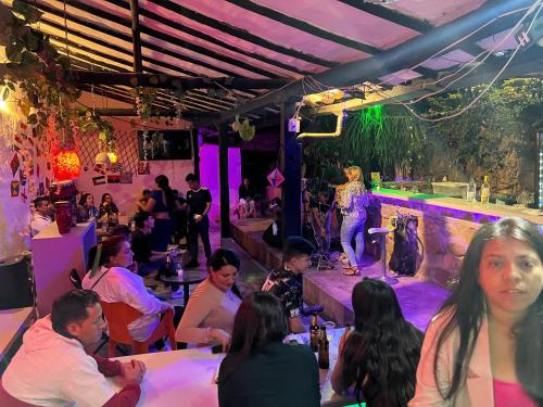 a group of people sitting at tables in a party at Green Door San Gil in San Gil
